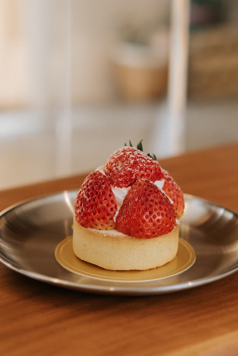 A strawberry tart on a metal plate